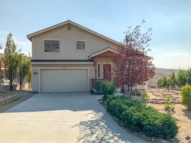 4958 Westridge Road Bishop, CA 93514 - Photo 2 of 24 a front view of a house with a yard and garage