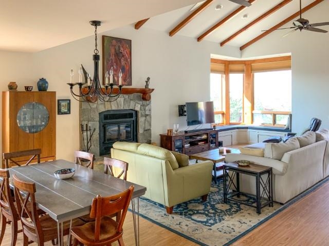 4958 Westridge Road Bishop, CA 93514 - Photo 6 of 24 a living room with furniture a fireplace and a large window