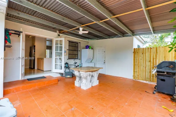 a view of a room with chairs and table in a patio