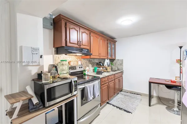 a kitchen with a stove window and cabinets
