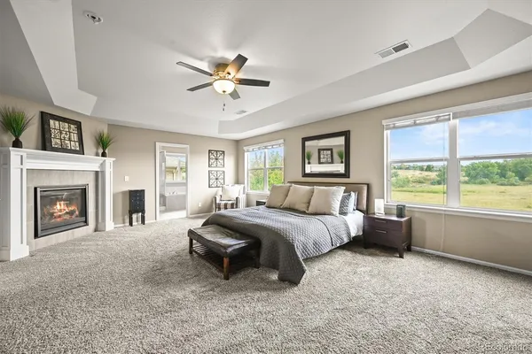 a spacious bedroom with a large bed and a fireplace