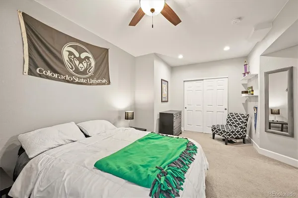 a bedroom with a large bed and a chandelier