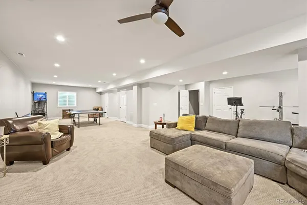 a living room with furniture and a view of kitchen