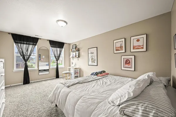 a bedroom with a large bed and a large window