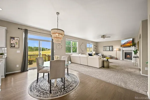 a living room with furniture a dining table and a window