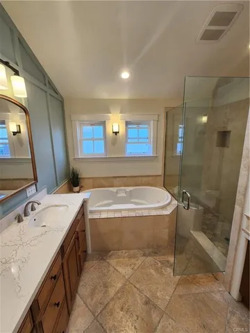 a bathroom with a granite countertop sink a toilet and shower