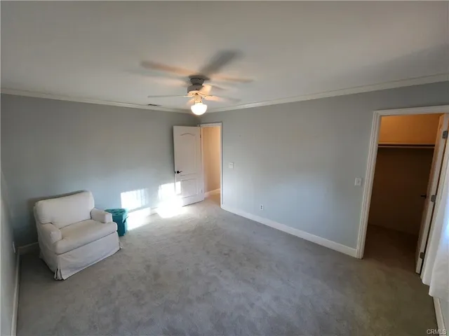 a living room with furniture and a ceiling fan