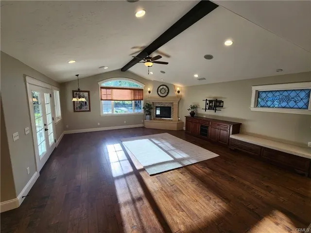 a living room with stainless steel appliances kitchen island granite countertop furniture a large window
