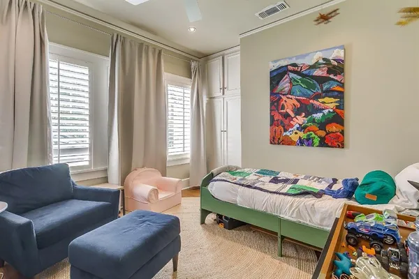 a bedroom with a bed and a couch