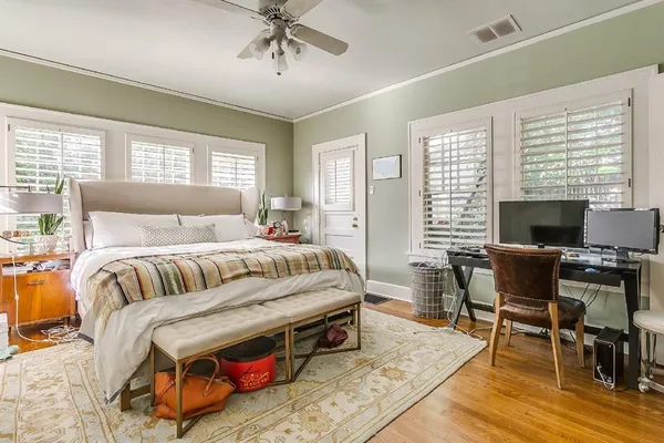 a bedroom with bed and a flat screen tv