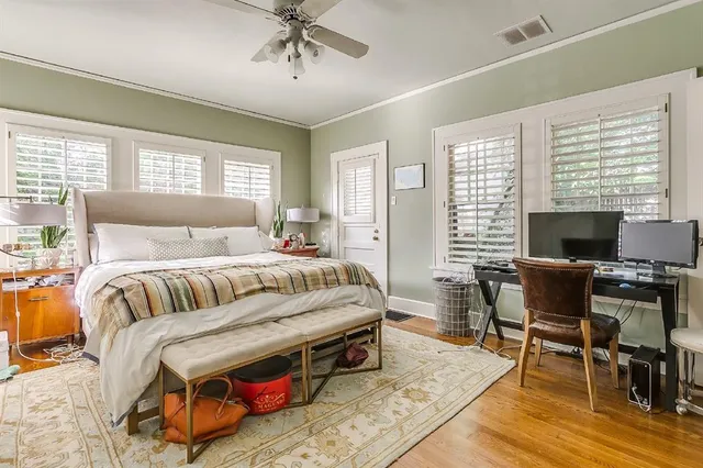 a bedroom with bed and a flat screen tv