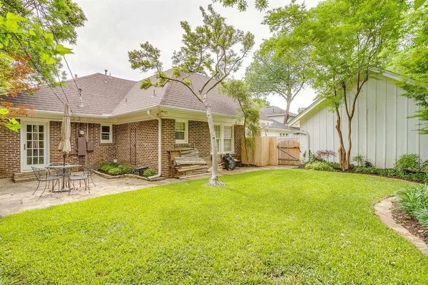 a view of a house with a yard and sitting area