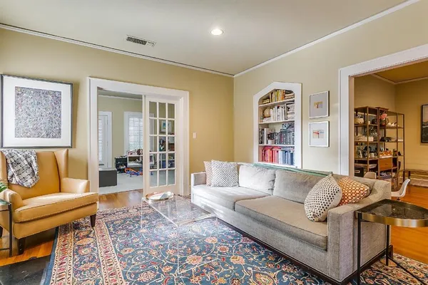 a living room with fireplace furniture and wooden floor