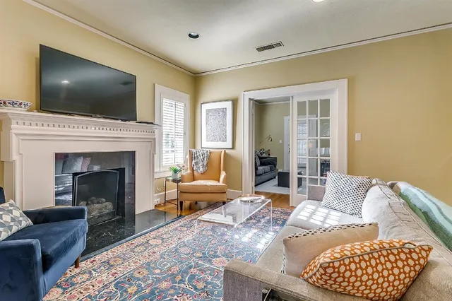 a living room with a flat screen tv and a fireplace