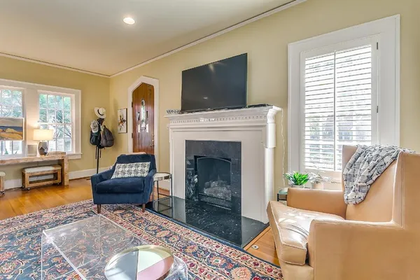 a living room with furniture and a fireplace