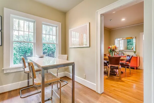 a view of a dining room with furniture and wooden floor