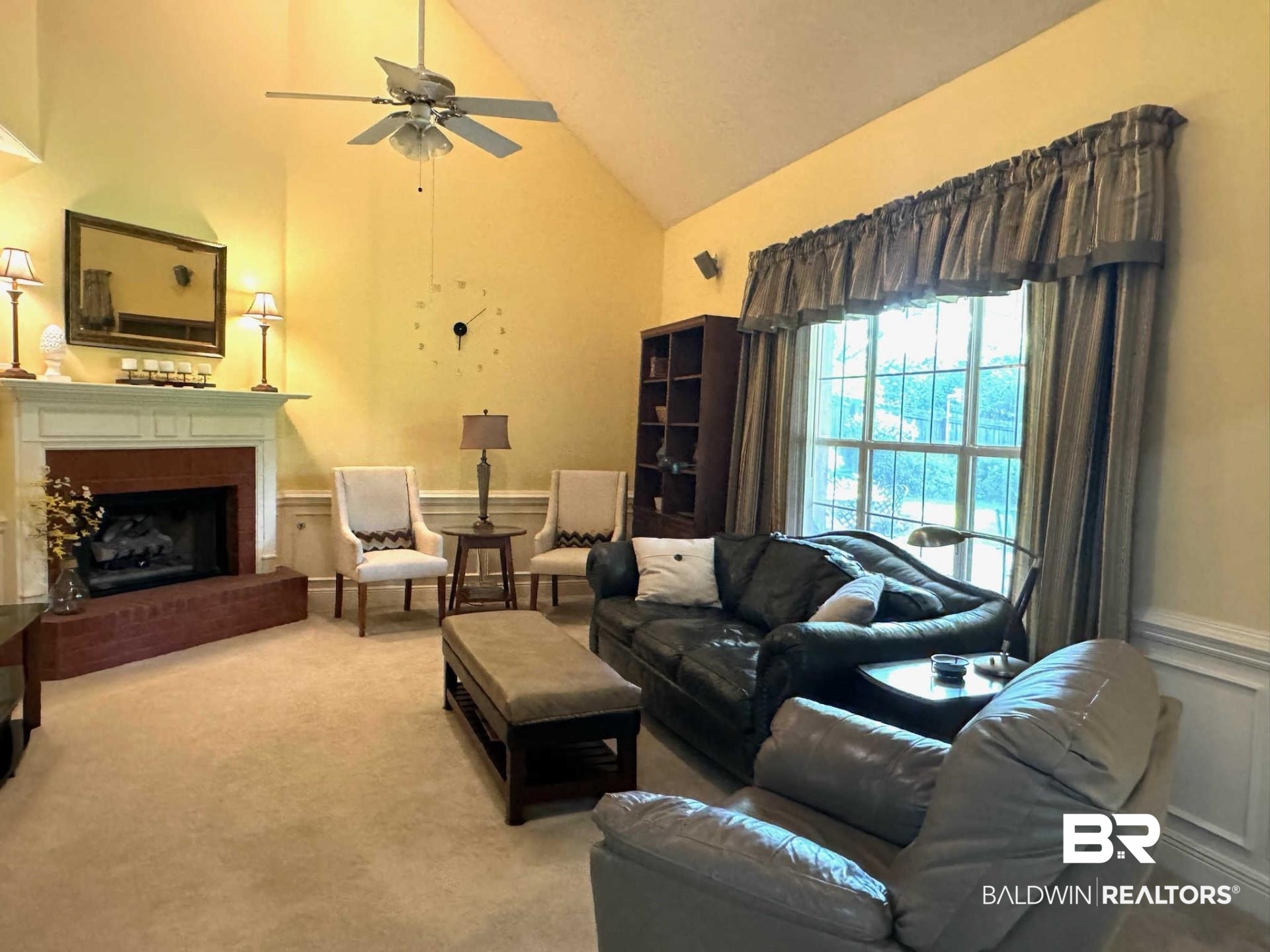 31163 Woodland Way Daphne, AL 36527 - Photo 16 of 44 Carpeted living room featuring ceiling fan, high vaulted ceiling, and a fireplace