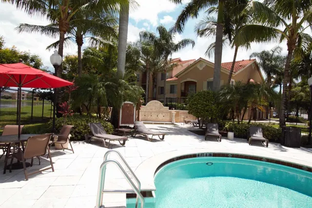 a view of swimming pool with outdoor seating and plants