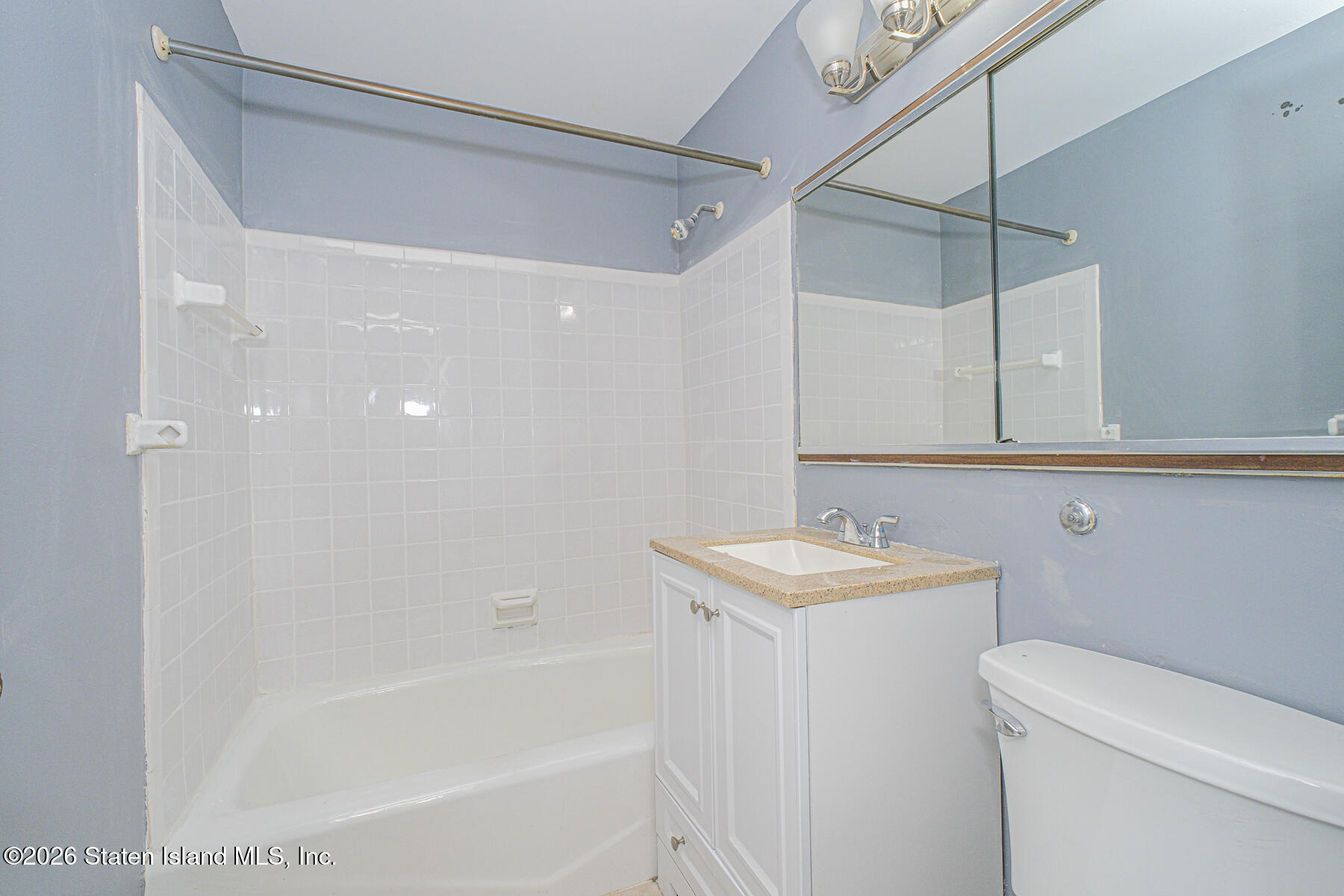 1000 Clove Road, Unit 7F Staten Island, NY 10301 - Photo 11 of 16 a bathroom with a sink a toilet and shower