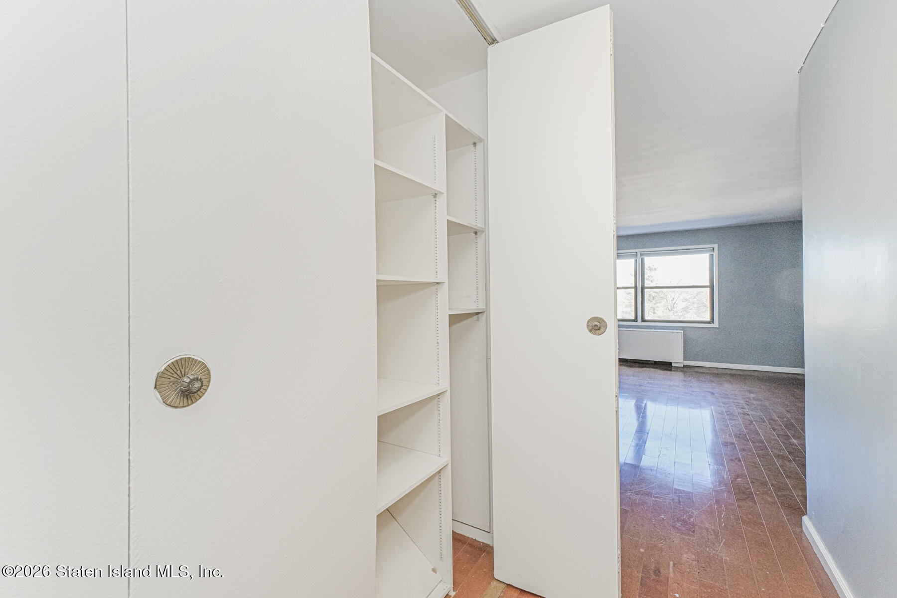 1000 Clove Road, Unit 7F Staten Island, NY 10301 - Photo 13 of 16 a view of a hallway with wooden floor and closet