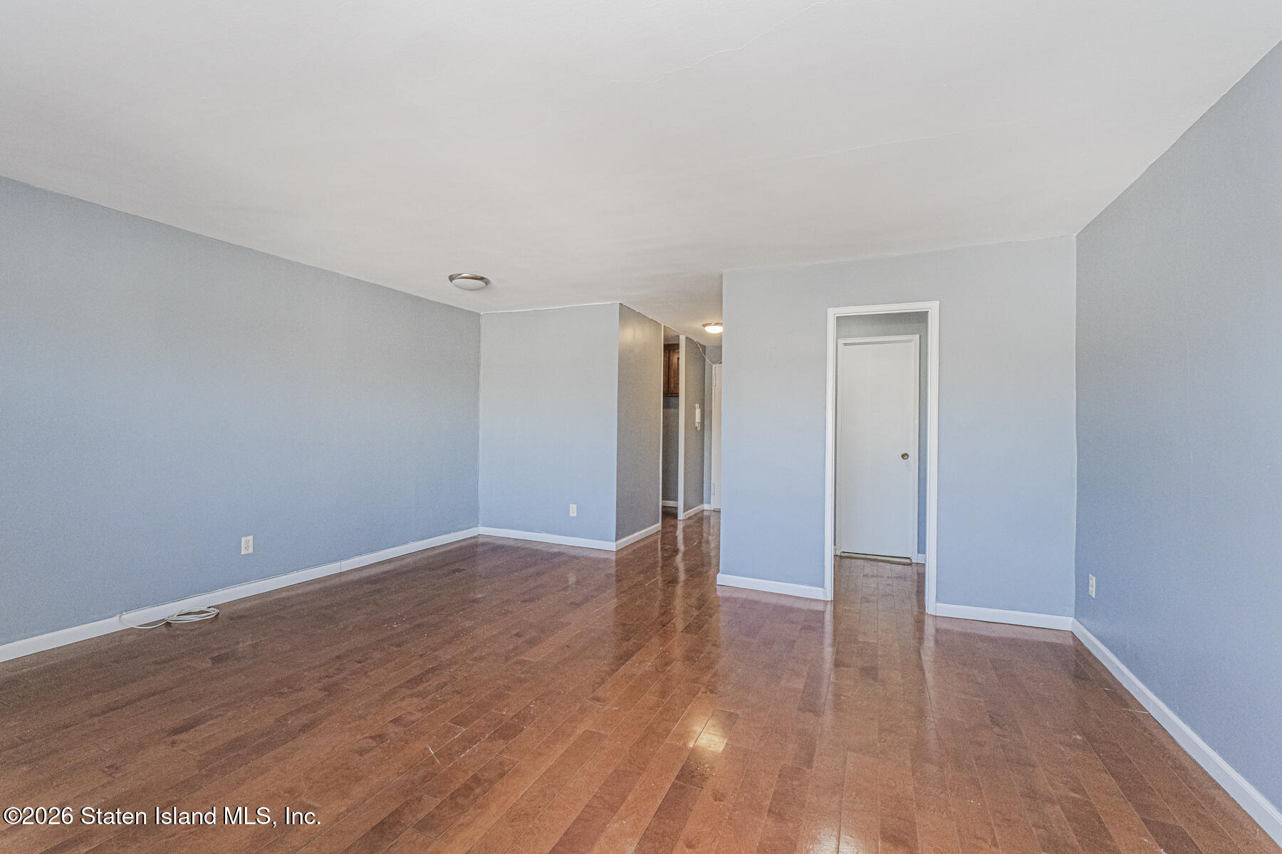 1000 Clove Road, Unit 7F Staten Island, NY 10301 - Photo 7 of 16 a view of an empty room with wooden floor