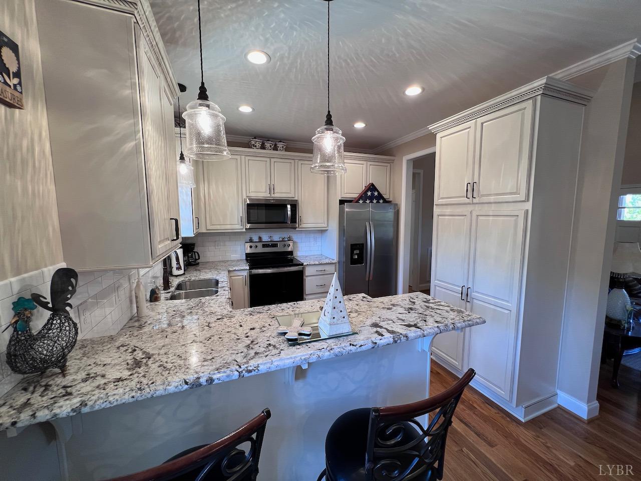 198 Oxford Furnace Road Lynchburg, VA 24504 - Photo 12 of 33 a kitchen with stainless steel appliances kitchen island granite countertop a sink refrigerator and microwave