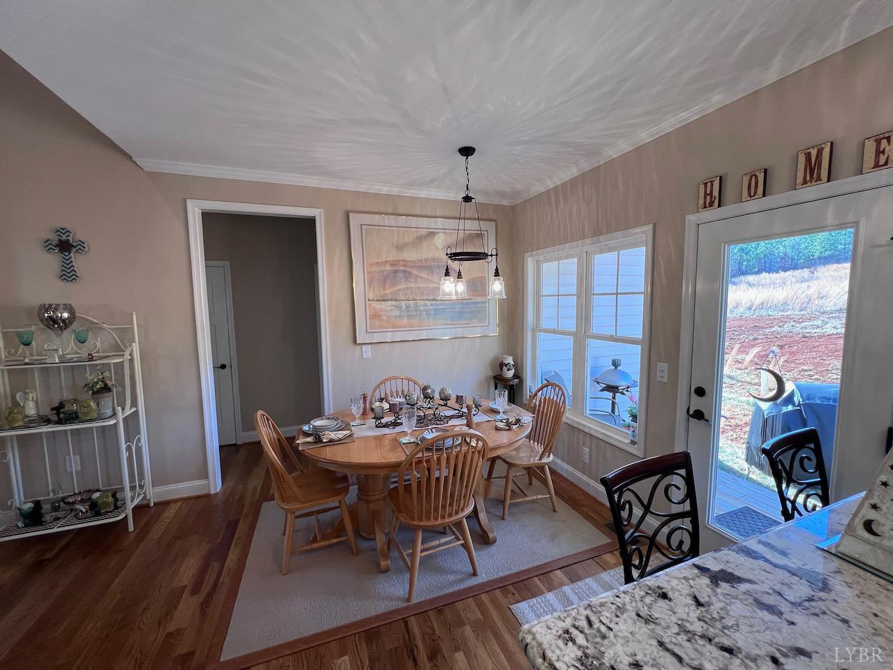 198 Oxford Furnace Road Lynchburg, VA 24504 - Photo 15 of 33 a dining room with furniture a rug a fireplace and wooden floor