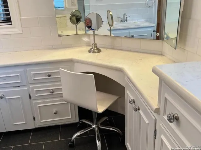 a kitchen with a sink cabinets and wooden floor