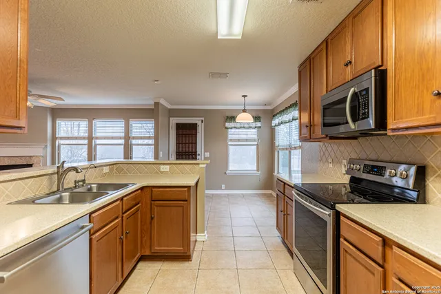 a kitchen that has a sink and a stove