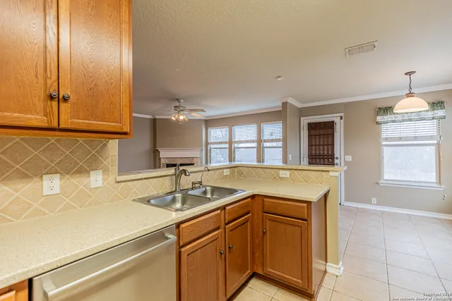 a kitchen that has a sink and a stove in it
