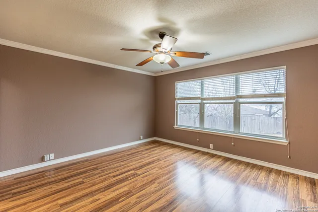 wooden floor in an empty room with a window