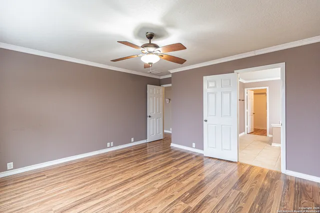 a view of an empty room with wooden floor