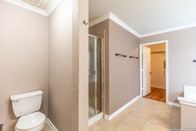 a bathroom with a toilet and a shower