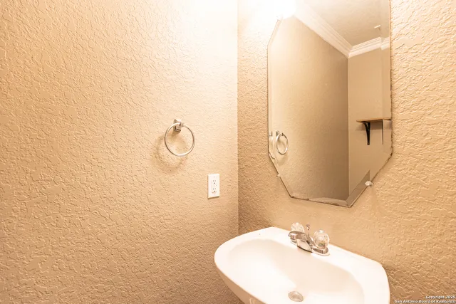 a bathroom with a sink and mirror