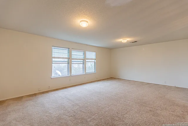 an empty room with a empty space and windows