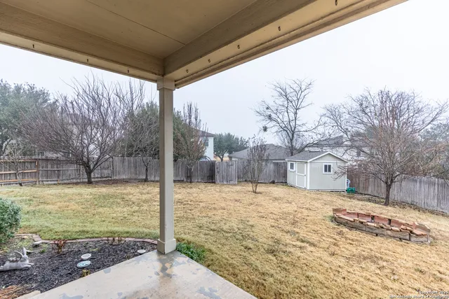a view of a house with a yard and sitting area