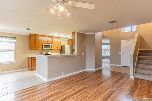 a view of a kitchen with wooden floor and a kitchen