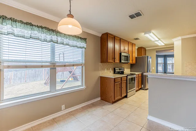 a kitchen with stove and window