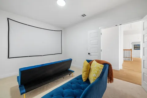 a bedroom with a beds and a chandelier