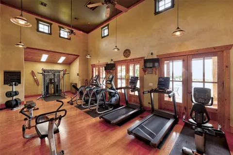 a room with gym equipment and view of living room
