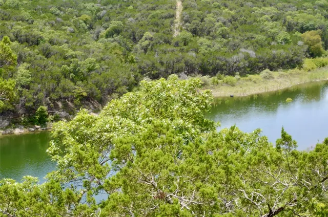 a view of a lake with houses with green space