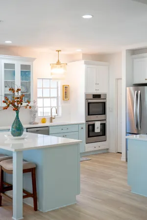 a kitchen with stainless steel appliances a dining table chairs and wooden floor