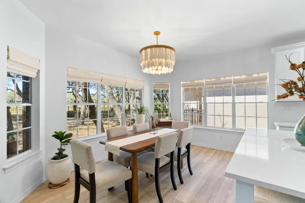 a kitchen with stainless steel appliances kitchen island granite countertop a refrigerator and a stove top oven