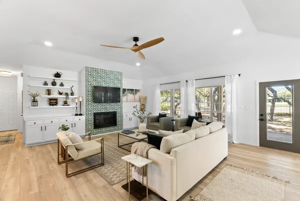 a living room with furniture flat screen tv and a fireplace