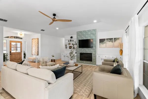 a living room with furniture fireplace and a flat screen tv