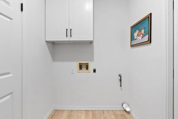 a bedroom with a bed a dresser and a window