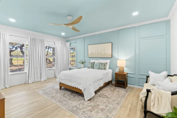 a spacious bedroom with a bed and a couch