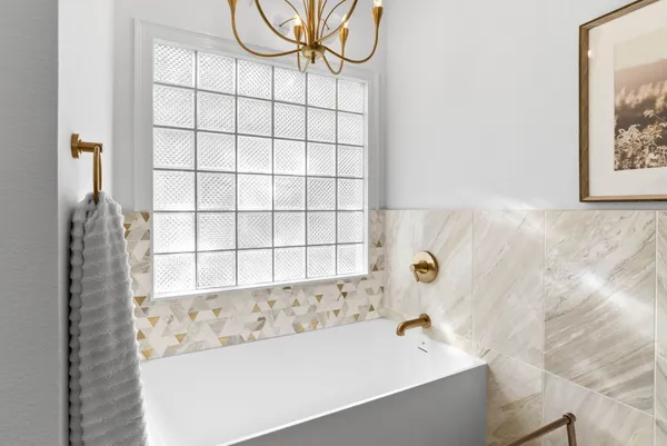 a bathroom with a bathtub and shower