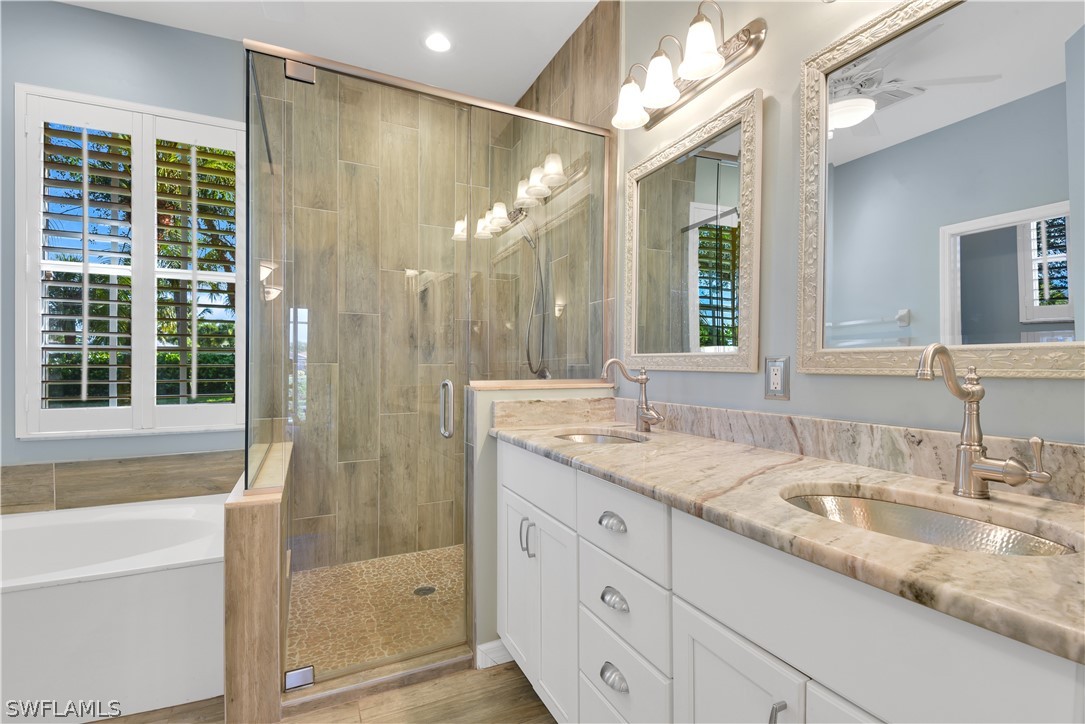 12834 Timber Ridge Drive Fort Myers, FL 33913 - Photo 14 of 31 a bathroom with a granite countertop sink mirror and a shower
