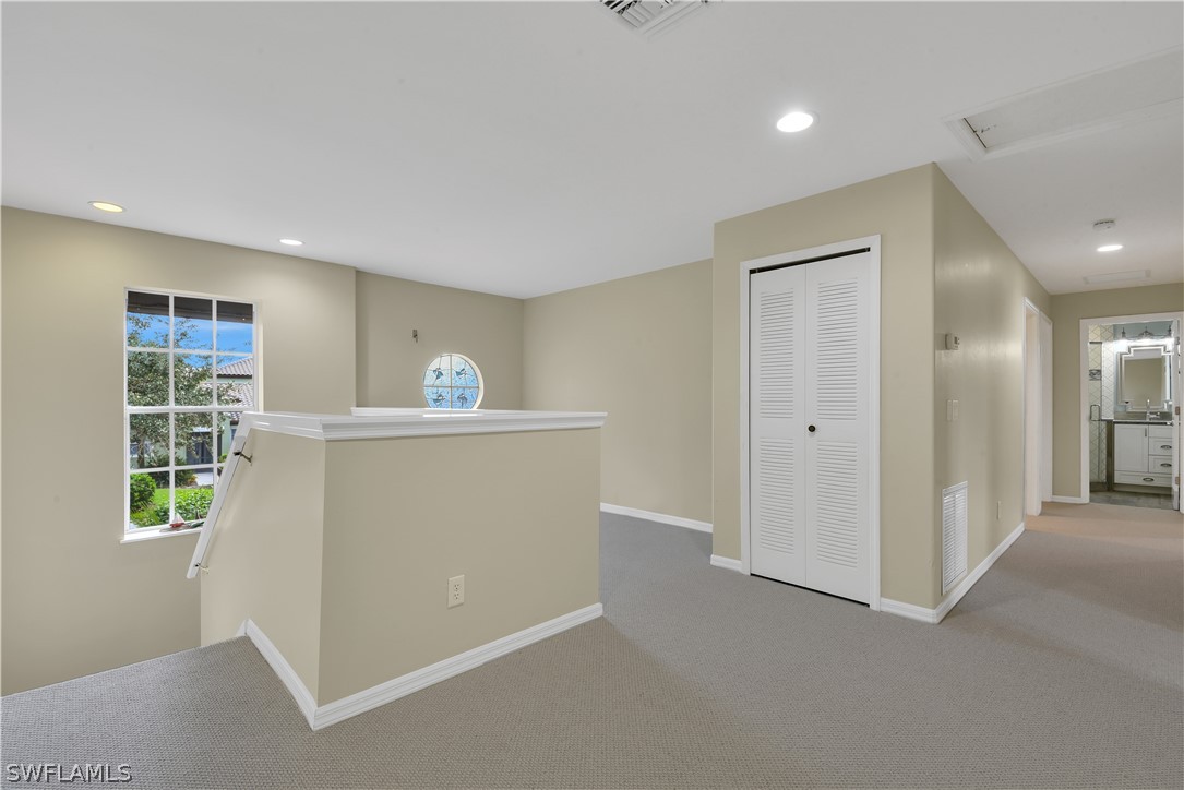 12834 Timber Ridge Drive Fort Myers, FL 33913 - Photo 16 of 31 a view of a hallway to room with window and cabinet